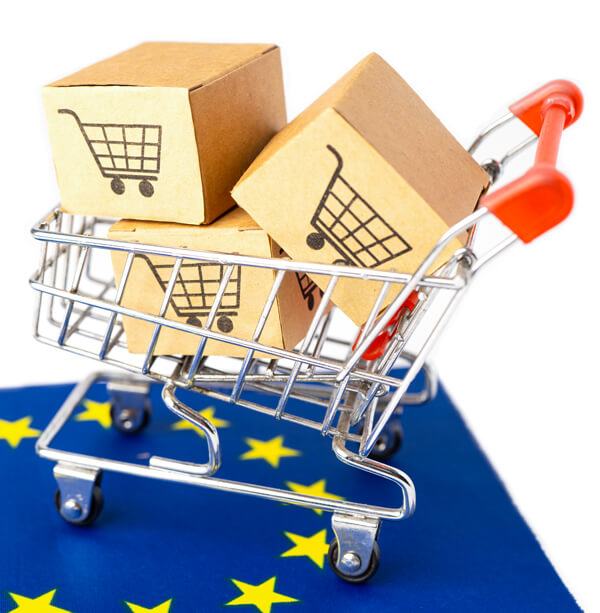 Targhe Industriali Milano - Scatole di prodotti in un carrello sulla bandiera Europea